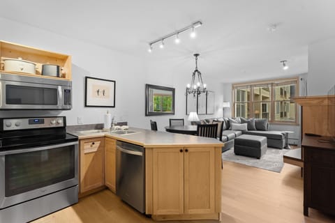Your open-plan kitchen flows seamlessly into a cozy living area with modern appliances and comfortable seating for relaxing after a day of exploring.