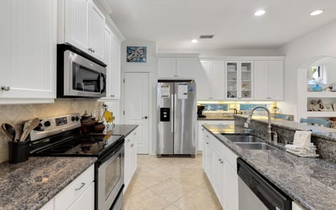 Cook your favorite meals in this elegant kitchen featuring granite counters, stainless appliances, and everything you need for a perfect stay.