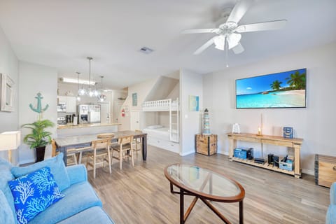 Your bright, airy living space features coastal vibes with comfortable seating, a full kitchen, and bunk beds perfect for families.