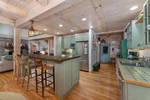 Kitchen with bar seating for 3, dishwasher, and standard drip-style coffeemaker.