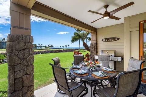 Lanai of this rental with grill and outside seating.