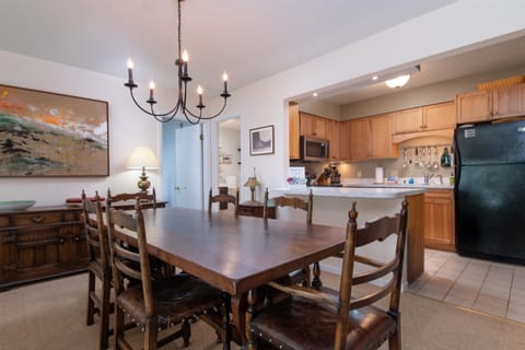 - Rustic dining table with seating for family meals   - Beautiful chandelier adds a warm inviting glow   - Open plan flows into kitchen and living room area