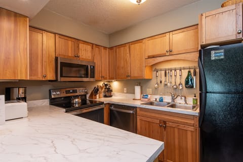 - Fully stocked kitchen with wood cabinetry design   - Modern stainless steel appliances for easy cooking   - Spacious counters ideal for preparing family meals