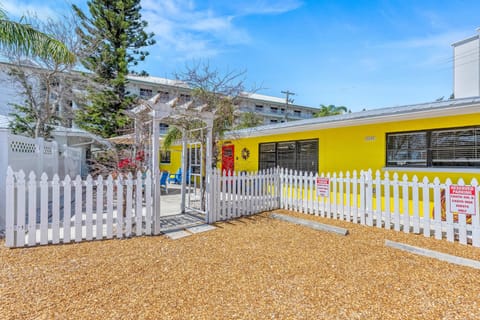 Step onto the cheerful front patio where colorful seating makes morning coffee feel like a vacation ritual.