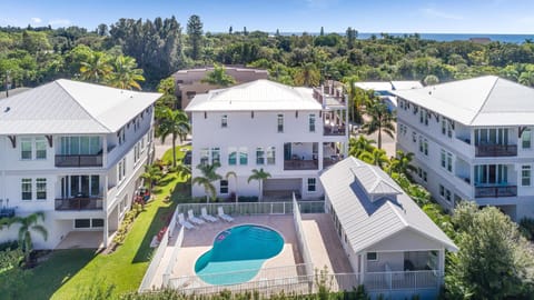Tucked beneath the palms—your private oasis awaits with a sparkling pool just steps from the shore.