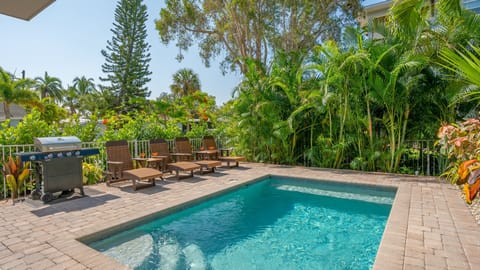 Slip into sun-drenched serenity—your private heated pool is calling from beneath the palms.