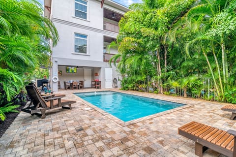 Your private resort moment: sparkling pool, stylish patio, cabana hideaway, and lush palms swaying in the coastal breeze—paradise is yours.