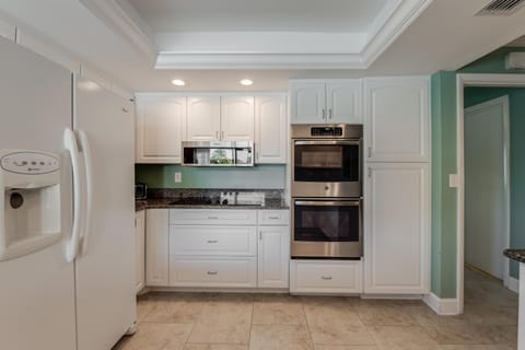 Feel the cool touch of marble countertops as you prepare meals surrounded by thoughtful details designed for effortless cooking and shared moments.