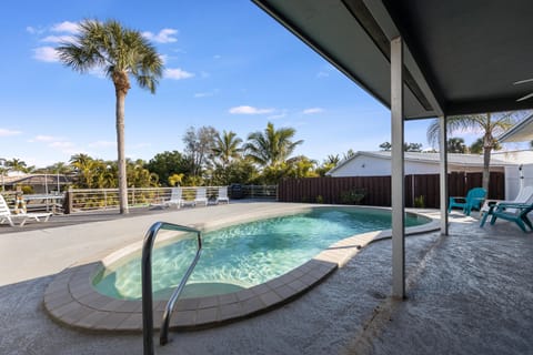 Slip into sun-drenched serenity where a heated pool invites you to unwind beneath swaying palms and warm Florida skies.