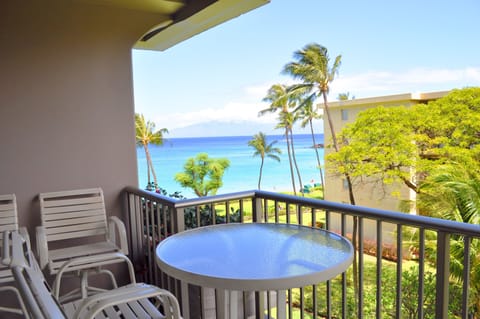 Step onto your private balcony and breathe in the ocean breeze. Sip morning coffee at your table while palm trees sway and turquoise waters sparkle just steps away.