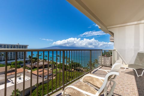Relax on your private balcony and soak in stunning ocean views. Two lounge chairs invite you to bask in the tropical sunshine while palm trees sway below.