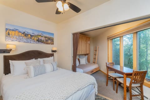 100B-The studio condo has a queen sized bed featuring murphy twin bunk beds that fold out from the wall.