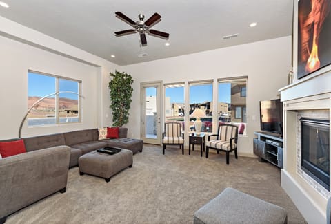 Living Room View - The living room is conveniently adjacent to the kitchen. There is also access to the back patio which has a BBQ grille suitable for all your favorite BBQ dishes.