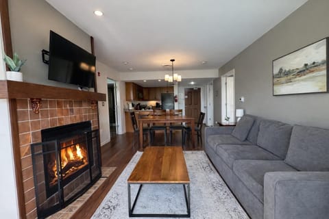 Cozy living room with fireplace and open dining area