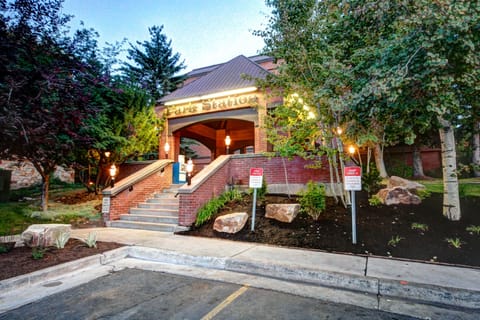 Park Station Condominium's steps leading to a covered entry with black lamp posts lighting the way.