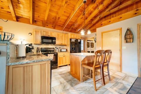 The kitchen features granite counters and all the cooking tools and utensils needed to prepare meals at home. 