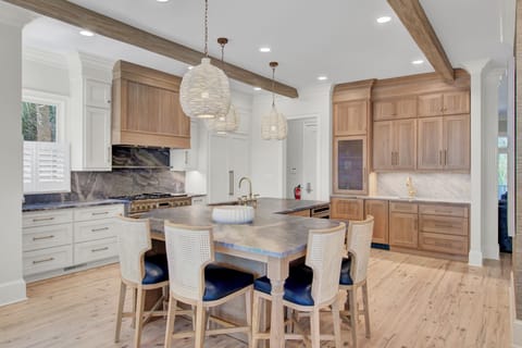 Kitchen features an island and a counter with barstool seating.