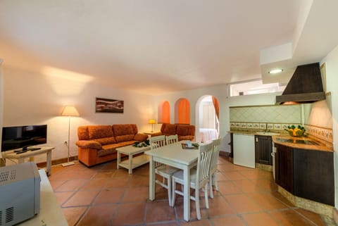 Table, chairs, sofas and table of Lavanda and Romero apartments living room in Hacienda Roche Viejo in Conil