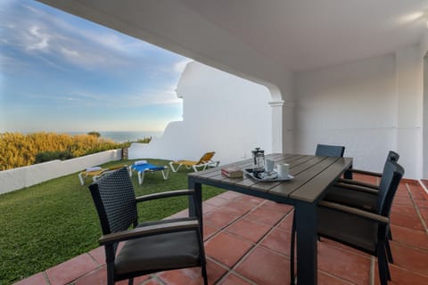 Table and chairs with sea views from Villa Castilnovo Terrace in Villas Flamenco Beach in Conil