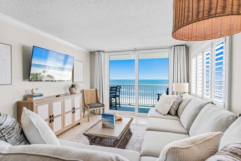 Unwind in your bright living room where ocean breezes flow through sliding doors to your private balcony with stunning sea views.