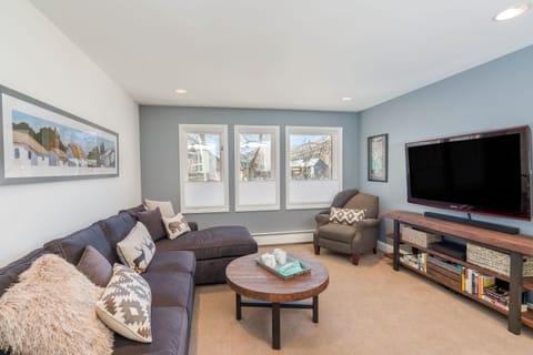 Living Room with Sectional Sofa, Armchair, and Smart TV