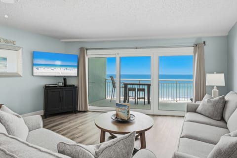 Step into your bright coastal sanctuary where soft sofas invite relaxation and the balcony doors frame endless ocean views. Feel the sea breeze and hear the waves as you unwind in this perfectly peaceful retreat.