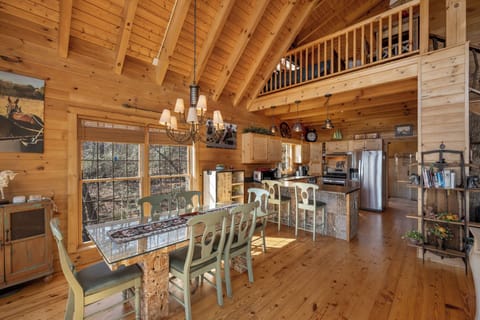 Gather around your rustic dining table in this warm log cabin retreat, where exposed beams and natural light create the perfect mountain escape.