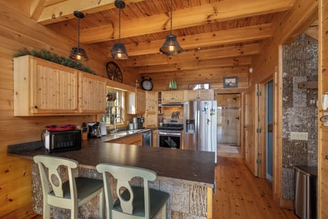 Your rustic kitchen awaits with warm wood beams, modern appliances, and cozy pendant lighting for memorable meal prep.