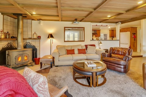 Cozy and inviting living room upstairs with wood stove for dry heat in the winter.
