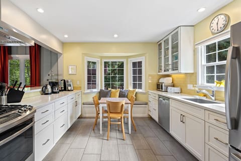Beautifully remodeled kitchen with ample light and stainless steel appliances.