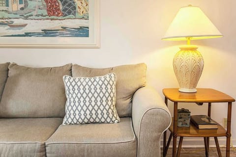 - Cozy sofa corner with patterned pillow, side lamp, and warm neutral tones
- Perfect place for curling up with a book or enjoying a relaxed conversation
- Coastal inspired decor brings both comfort and charm into the space