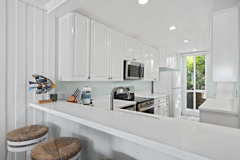 Fully stocked kitchen with bar seating, perfect for breakfast  or evening snacks