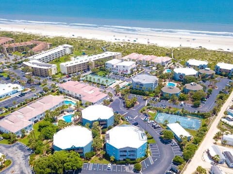 Aerial view of the stylish beachfront resort with multiple pools and villas.