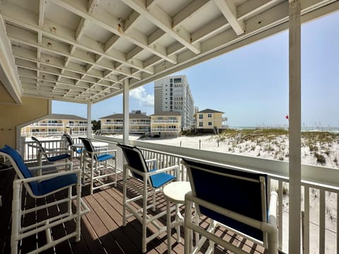 Your private balcony overlooks pristine white sand dunes, perfect for morning coffee while watching the beach come alive.