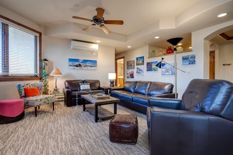 Sink into plush leather sofas in your spacious living room, where local artwork and warm lighting create the perfect atmosphere for relaxation.