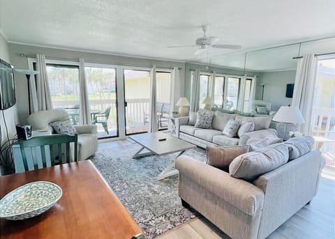 Relax in your bright, airy living space with plush seating and panoramic windows that flood the room with natural light.