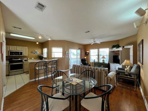 Relax in your spacious open-concept living area where warm wood floors and comfy furnishings create the perfect space for memorable meals and cozy evenings.
