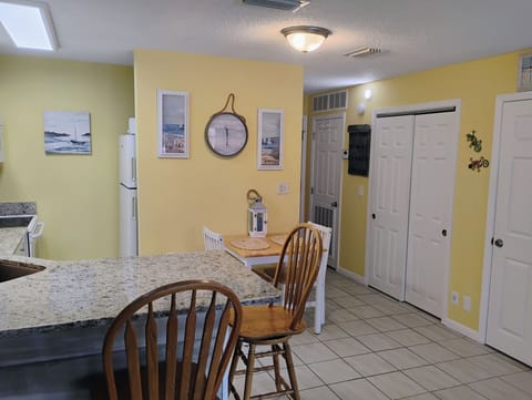 Your bright kitchen-dining space features cheerful yellow walls and granite counters, perfect for morning coffee or sharing meals together.