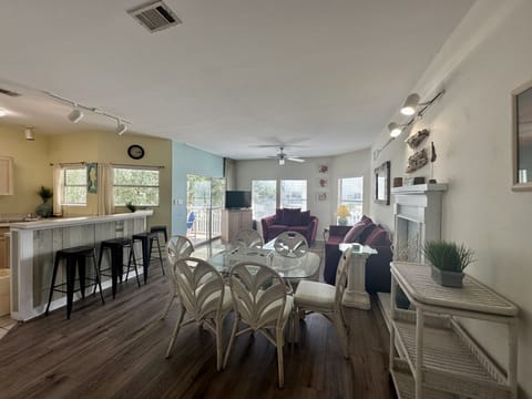 Relax in your spacious open-concept living room with comfortable seating, modern kitchen access, and sliding doors to your private patio.