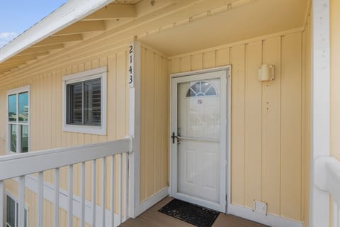 Property entrance marked with address number 2143, featuring a welcoming front door with decorative glass panel.