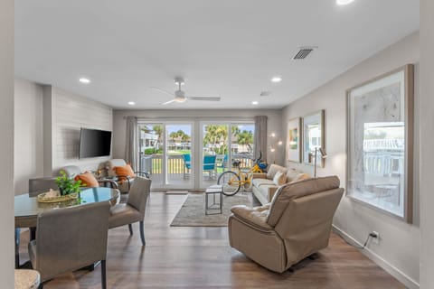 Unwind in your bright, airy living space with calming coastal views and easy access to the pool through sliding glass doors—perfect for lazy afternoons.