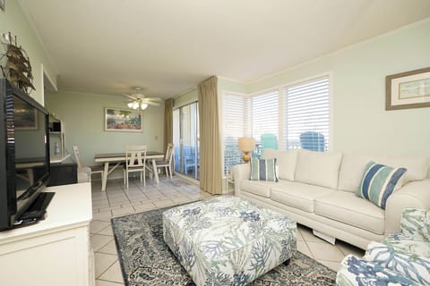 Relax in your bright coastal living space featuring comfortable seating, city views, and an open layout perfect for unwinding.