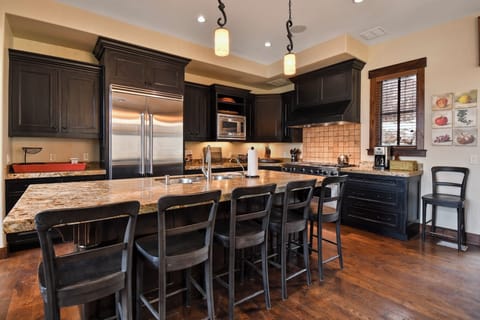 Your gourmet kitchen features granite countertops, stainless steel appliances, and a spacious island perfect for cooking memorable meals together.