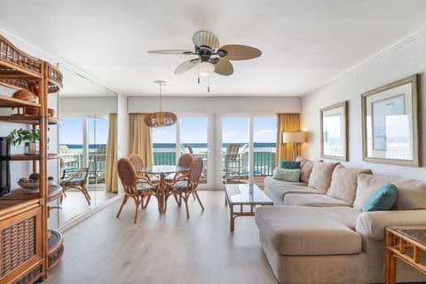 Relax in your spacious oceanfront living room where coastal breezes flow through sliding doors to your private balcony overlooking endless turquoise waters.