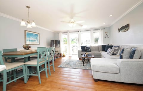 Sink into the plush sectional and let coastal charm embrace you in this bright, open living space with dining nook.