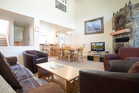 Relax in your spacious living area with vaulted ceilings, stone fireplace, and comfortable seating for the whole family to unwind together.