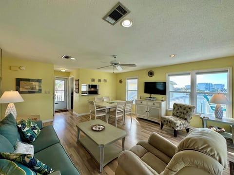 Unwind in your bright, coastal-style living space with water views and comfortable seating for relaxing evenings.