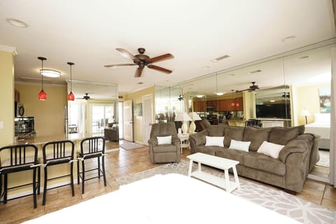 Unwind in your spacious open-plan living area where plush sectional seating and warm lighting create the perfect atmosphere for relaxation.