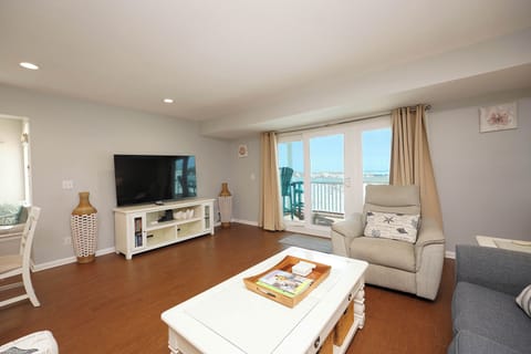 Unwind in your bright living room with comfortable seating and ocean views from your private balcony.
