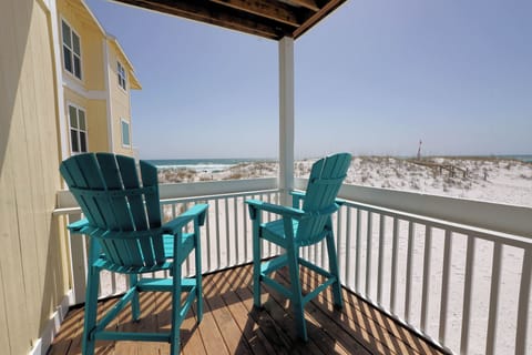Step onto your private balcony and sink into turquoise chairs overlooking pristine white sand dunes and sparkling ocean waves.